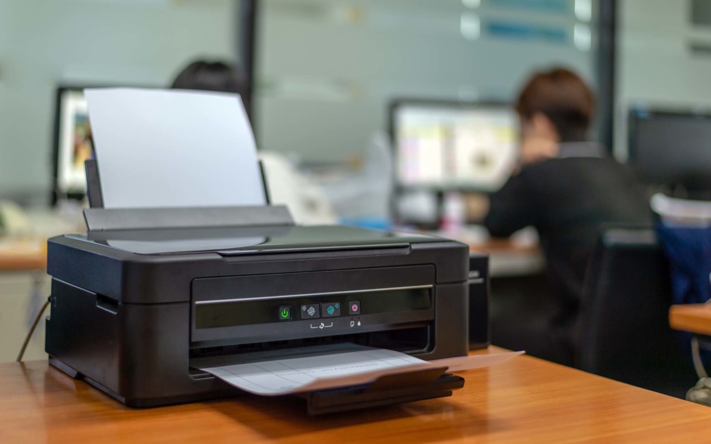 Small black office desktop printer on a table