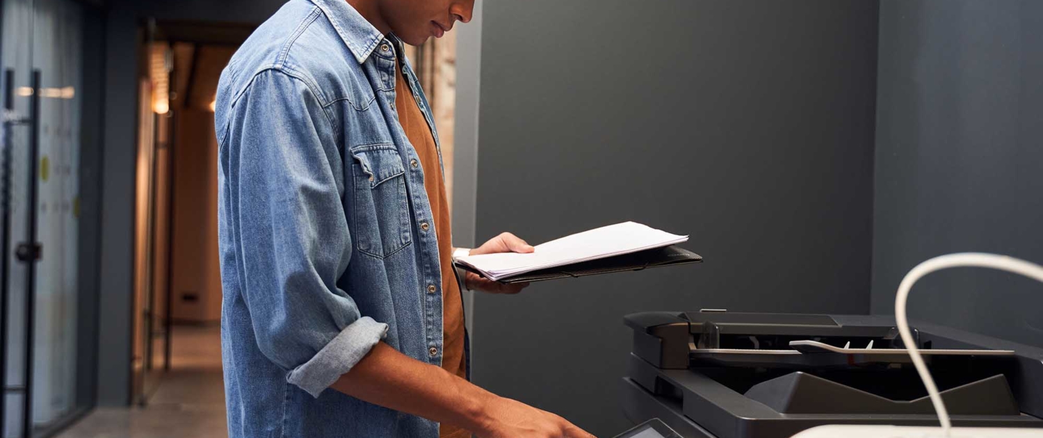 View of an office worker printing a file
