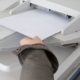 example of printer security risk, person grabbing random document from printer